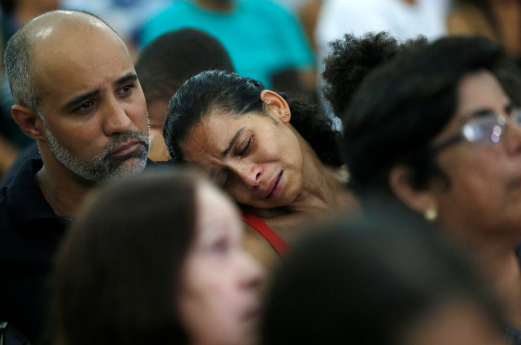 Relatives and friends of victims of a collapsed tailings dam owned by Brazilian mining company Vale SA, pay their respects during a mass in Brumadinho, Brazil January 31, 2019. Photo by Adriano Machado/Reuters