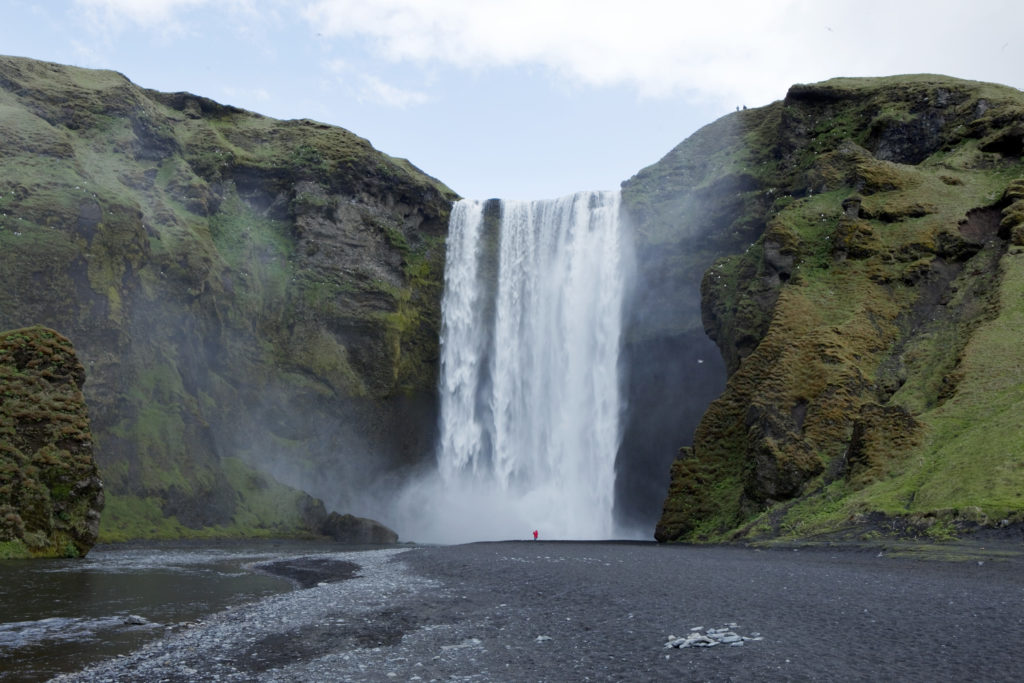 A woman stands in front of a waterfall in Skogarfoss, Iceland on May 28, 2011. Photo by Lucas Jackson/Reuters