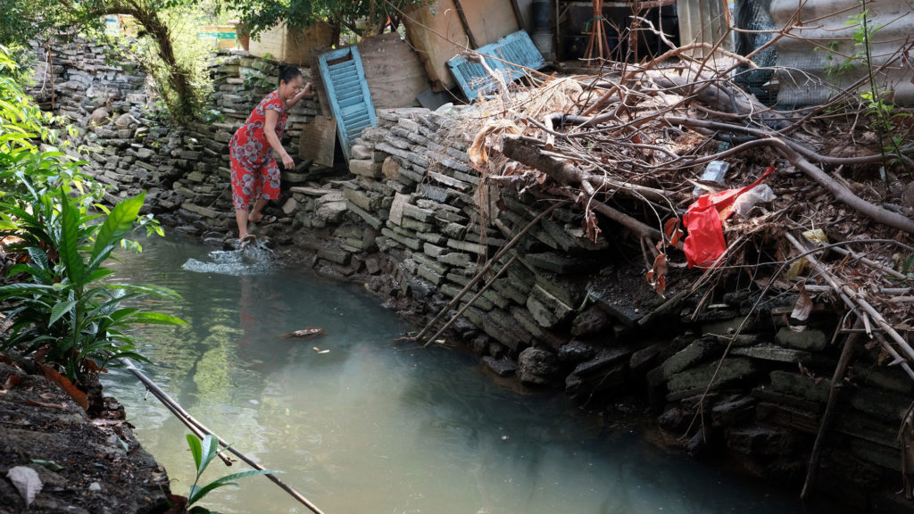 A woman who identified herself as Mrs. Mai washes her feet in the dioxin-laden Buu Long canal. Photo by Cuong Tran/FERN