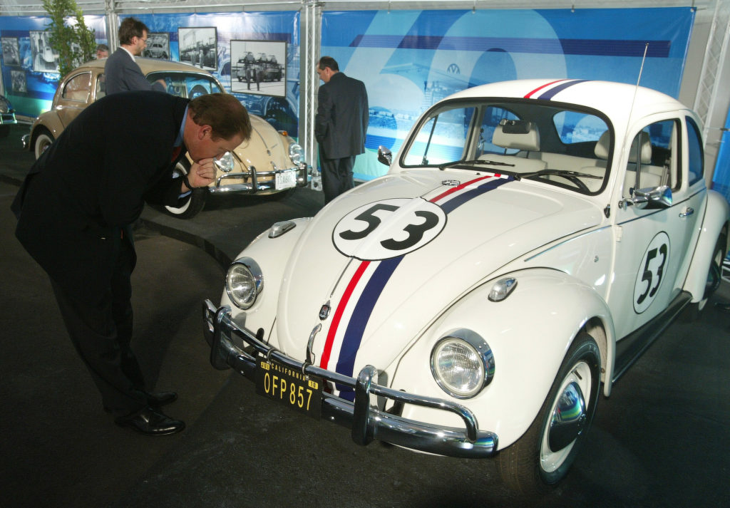 A visitor admires vintage VW Beetles replica of "Herbie" before the unveiling of the final edition of the VW Beetle at the Volkswagen plant where it is built in Puebla 100km east of Mexico City July 10, 2003. "Herbie" was a fictionalized sentient car in Disney movies. Photo by Andrew Winning/Reuters