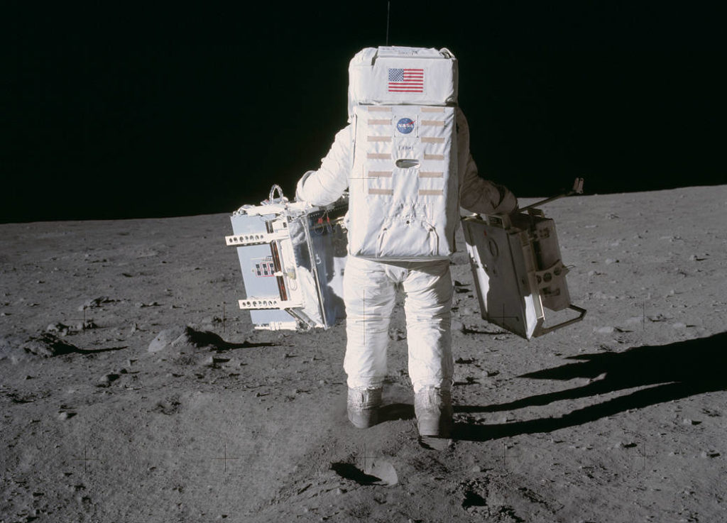 Astronaut Buzz Aldrin moves toward a position to deploy two components of the Early Apollo Scientific Experiments Package (EASEP) on the surface of the moon during the Apollo 11 extravehicular activity. Photo by NASA