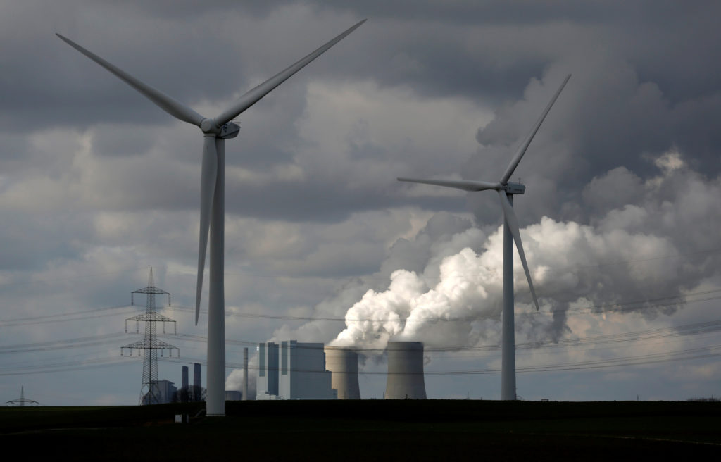 Wind turbines are seen in front of a coal power plant of German utility RWE Power near the western town of Neurath February 28, 2014. Photo by REUTERS/Ina Fassbender