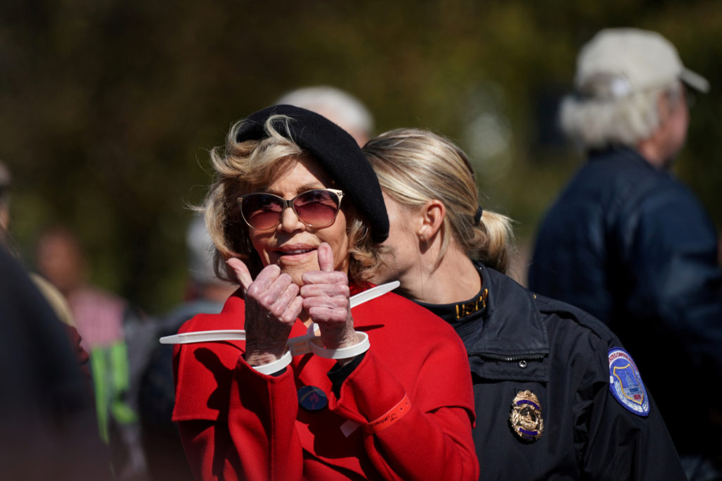 Actor and activist Jane Fonda gives a thumbs up in handcuffs as she is detained for blocking the street in front of the Library of Congress during the "Fire Drill Fridays" protest in Washington, U.S., October 18, 2019. Photo by Sarah Silbiger/Reuters