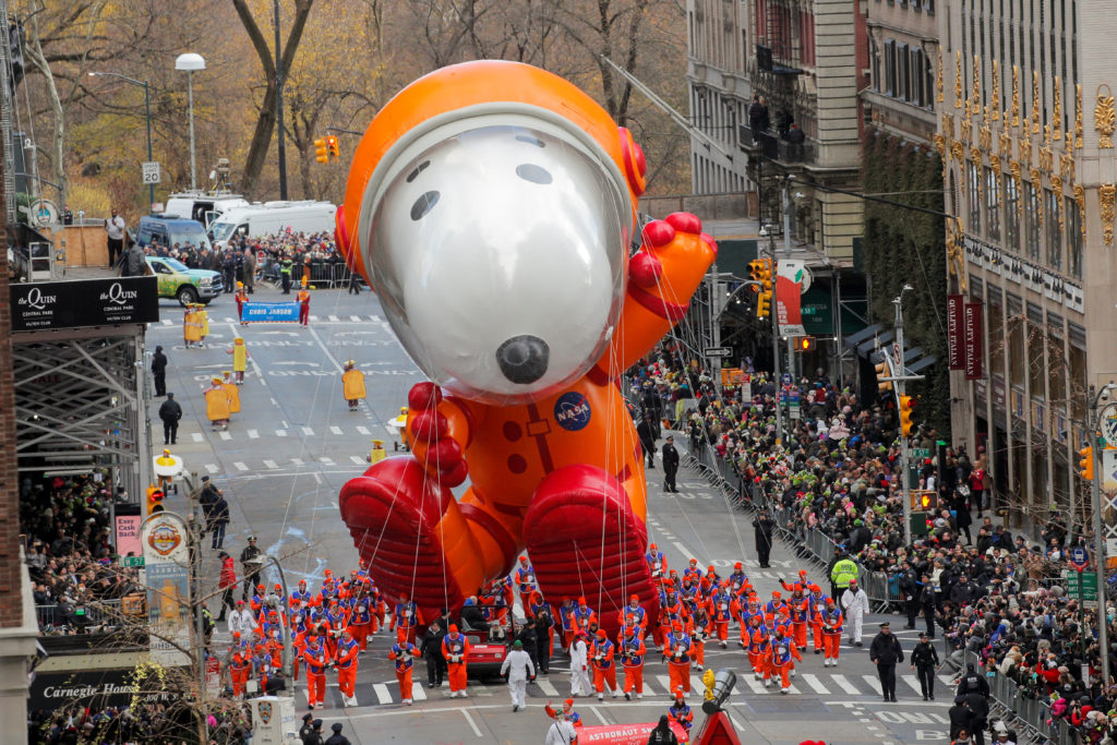 Astronaut Snoopy balloon hovers above the crowd during the 93rd Macy's Thanksgiving Day Parade in Manhattan,New York, U.S., November 28, 2019. Photo by Brendan Mcdermid/Reuters