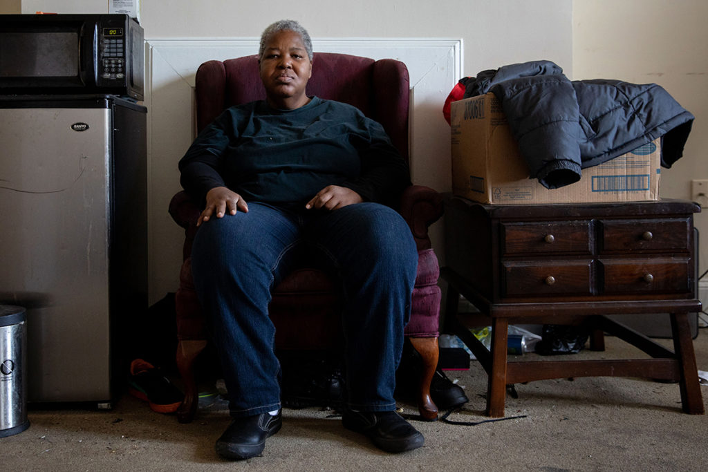 Sharon Bosley in her Baltimore home. Bosley, diagnosed as HIV positive 32 years ago, is studying computer information systems at Baltimore City Community College. Credit: Amanda Andrade-Rhoades