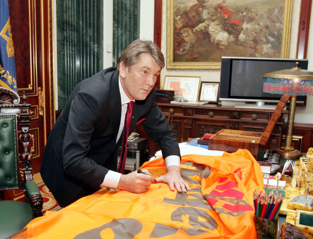 Ukrainian President Yushchenko signs an Orange flag in his office in Kiev