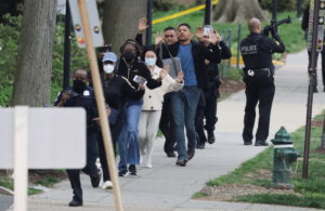 Law enforcement officers evacuate civilians to safety near scene of a reported shooting and active shooter near Edmund Bur...