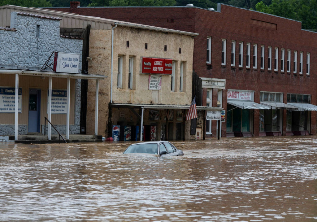 A car is submerged in flood waters along Right Beaver Creek, following a day of heavy rain in in Garrett, Kentucky, U.S. July 28, 2022. Photo by Pat McDonogh/USA TODAY NETWORK via REUTERS