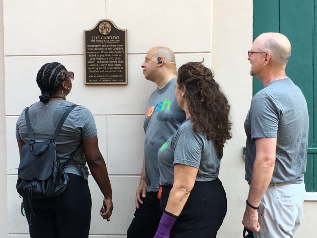 Tourists look at a slave marker in New Orleans