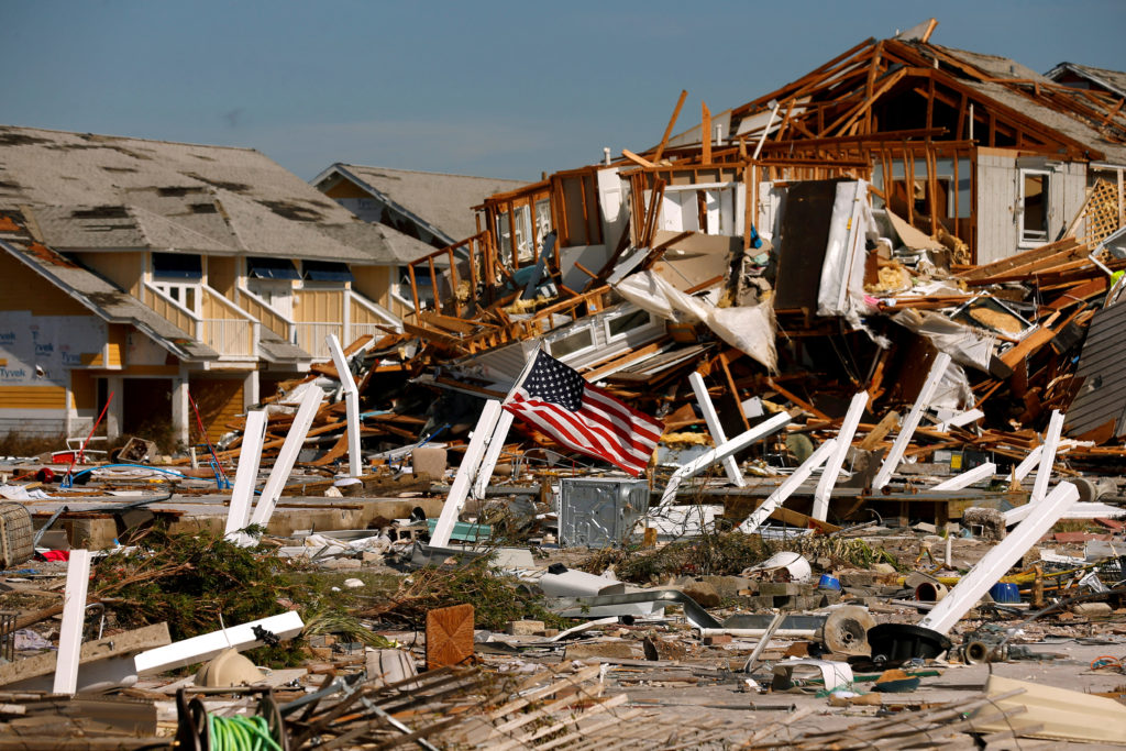 FILE PHOTO: An American flag flies amongst rubble left in the aftermath of Hurricane Michael in Mexico Beach