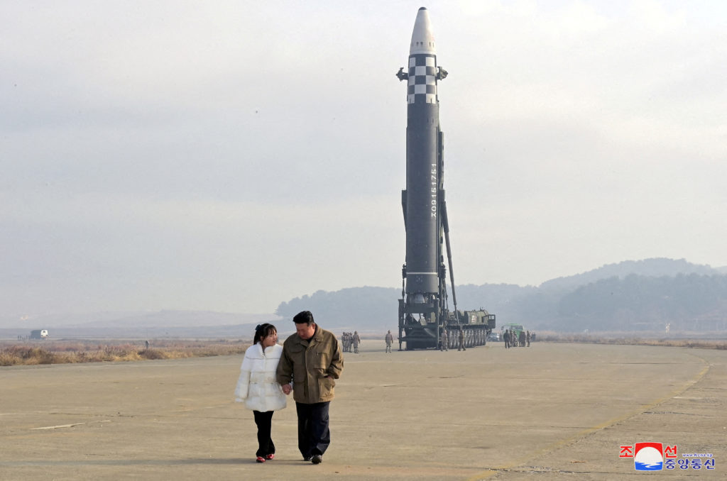 FILE PHOTO: North Korean leader Kim Jong Un, along with his daughter, walks away from an ICBM in this undated photo releas...