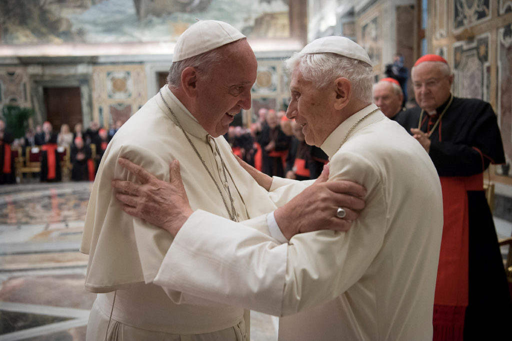 FILE PHOTO: Former pope Benedict is greeted by Pope Francis during a ceremony to mark his 65th anniversary of ordination t...