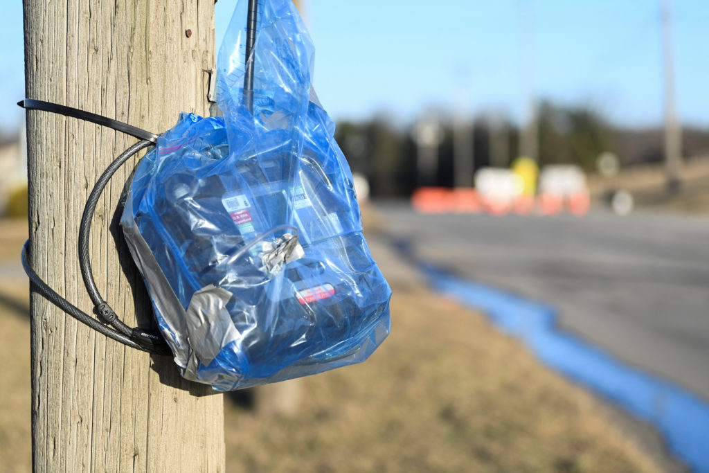 An air monitoring device is fixed to a pole following a train derailment that spilled toxic chemicals in East Palestine, Ohio