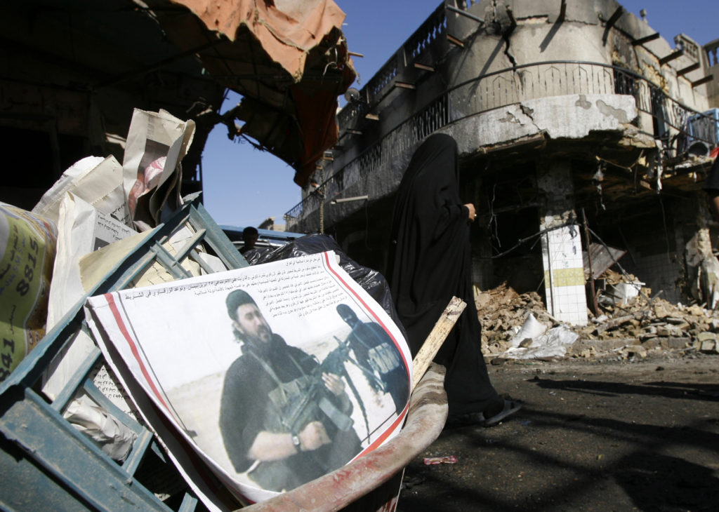 A newspaper with the picture of recently killed al-Qaeda leader Abu Musab al-Zarqawi lies with other things on a basket near a damaged house from Monday night's car bomb attack which killed 10 people and wounded 25 others in a market in western Baghdad, June 13, 2006. Photo by Ali Jasim/REUTERS