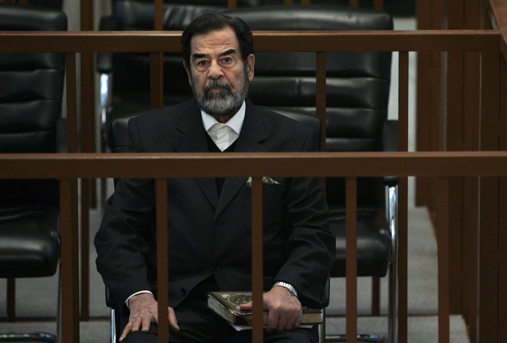 Saddam Hussein sits in court during the continuation of his trail in Baghdad, December 6, 2006. Photo by Chris Hondros/Pool/REUTERS