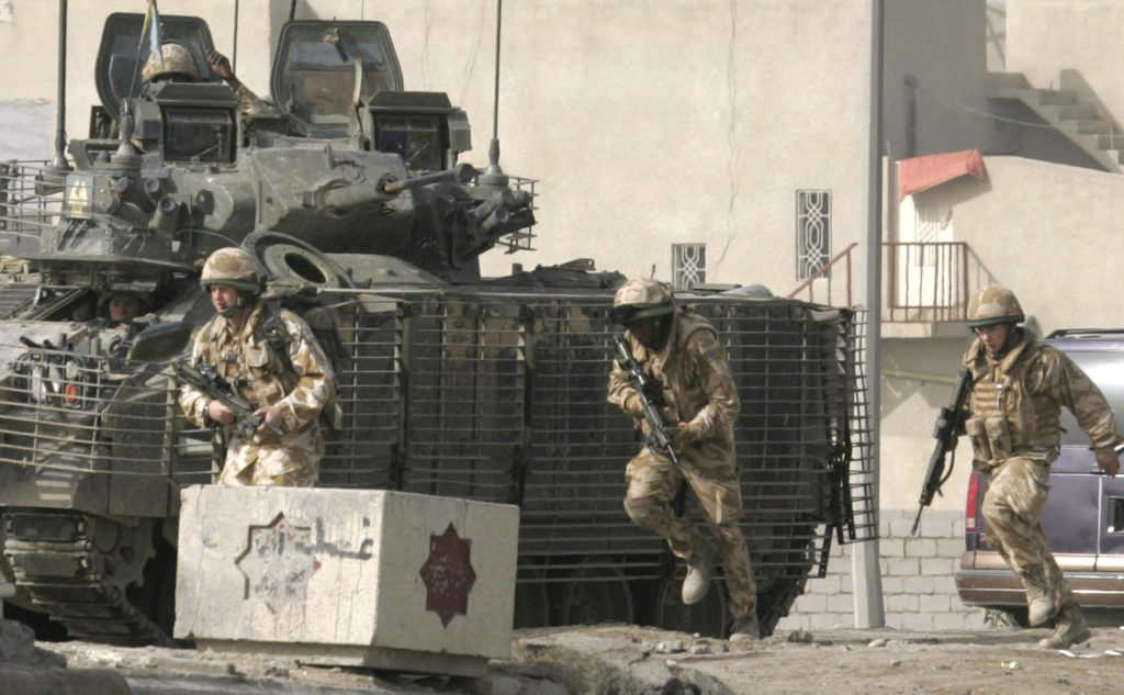 British soldiers patrol along a road after a roadside bomb attack in Basra, 550 km (340 miles) south of Baghdad, January 6, 2007. A British soldier was wounded when his convoy was hit by a roadside bomb but his injuries were not thought to be life threatening, Major Charlie Burbridge said. Photo by Atef Hassan/REUTERS