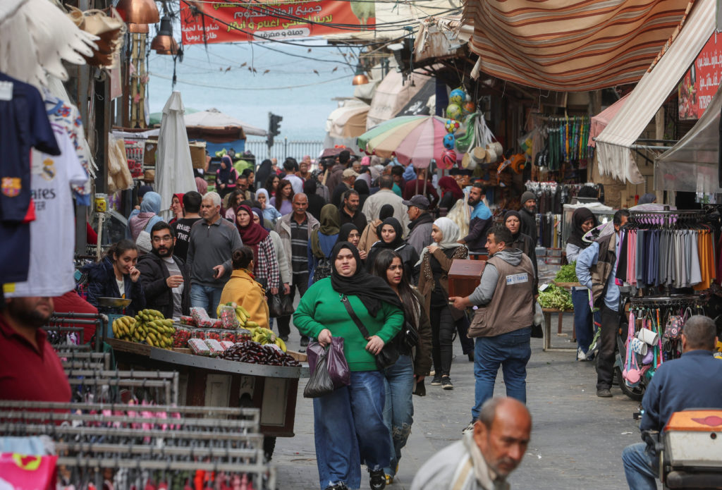 People shop at a souk ahead of the holy fasting month of Ramadan, in Sidon