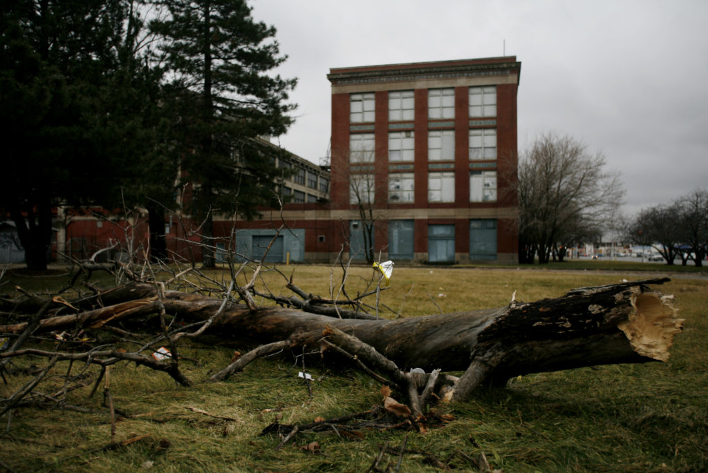 A fallen tree limb sits on the front lawn of the historic Ford Motor Company Highland Park factory in Highland Park, Michigan