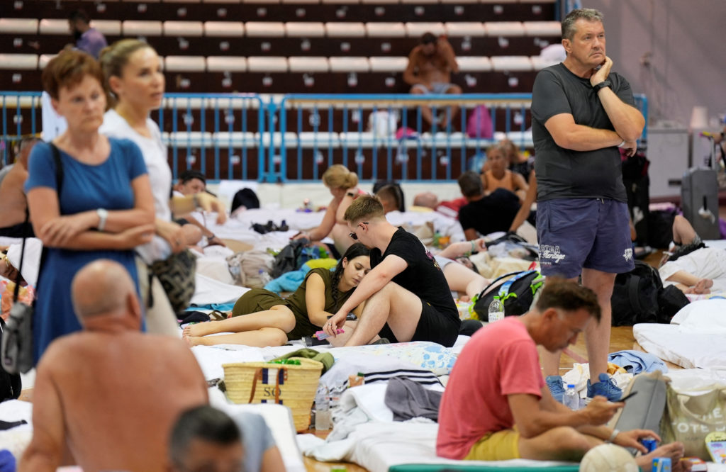 Tourists shelter in a school as wildfires burn forests on Greek island of Rhodes
