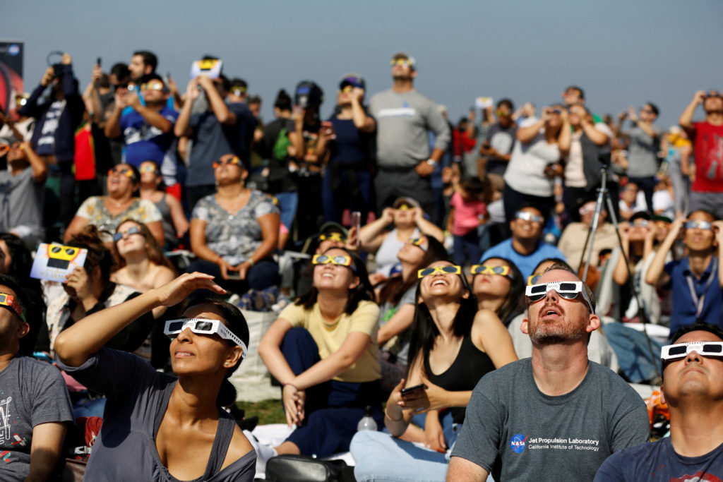 FILE PHOTO: People watch the solar eclipse on the lawn of Griffith Observatory in Los Angeles