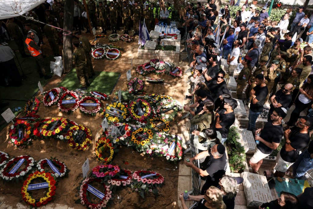 Israeli mourners attend the funerals of people who were slain in the assault on Israel by Hamas gunmen from the Gaza Strip...