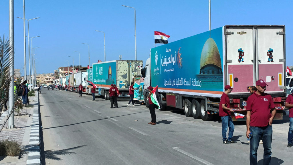 Trucks carrying humanitarian aid to Palestinians wait for an agreement on the Rafah border crossing to enter Gaza, in the ...