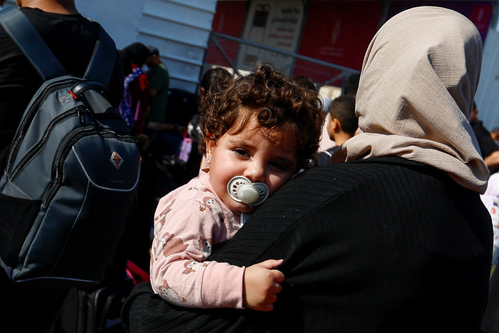 Palestinians with dual citizenship gather outside Rafah border crossing with Egypt