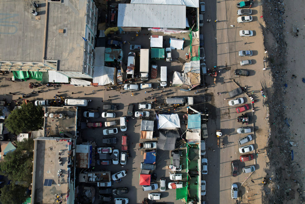 Palestinians gather to collect water at a United Nations-run school, in central Gaza Strip