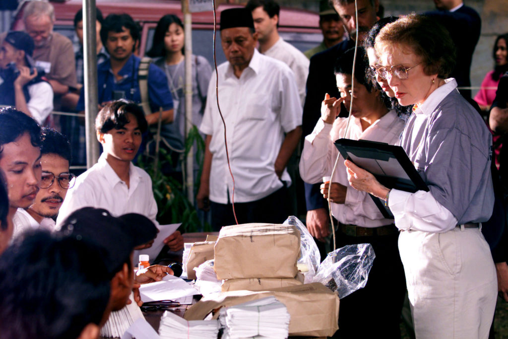 ROSALYNN CARTER TAKES NOTES AT A POLLING BOOTH IN JAKARTA.