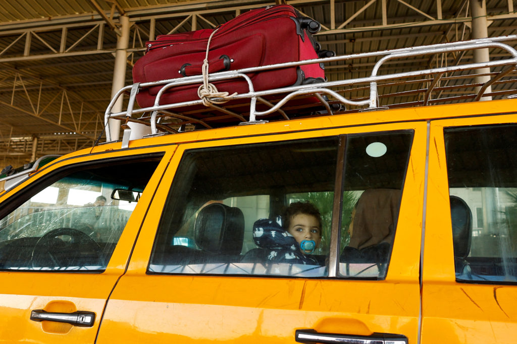 Palestinians with foreign passports arrive at the Rafah border crossing with Egypt