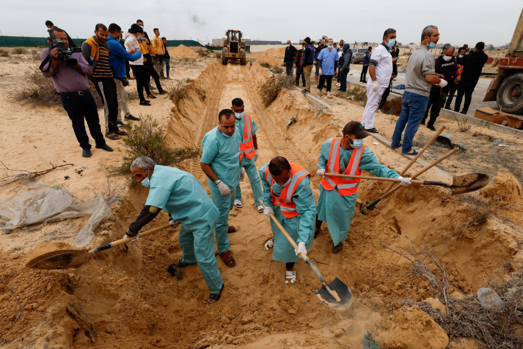Palestinians killed in Israeli strikes are buried in a mass grave in Khan Younis
