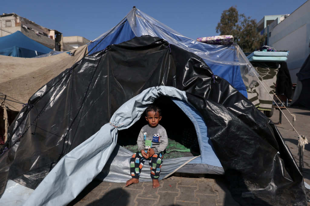 Palestinians, who fled their houses amid Israeli strikes, shelter at a United Nations-run school, in Khan Younis