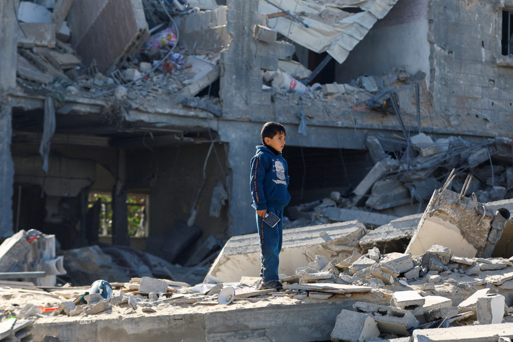 A Palestinian child looks on at the site of an Israeli strike on a house, amid the ongoing conflict between Israel and the Palestinian Islamist group Hamas, in Rafah, in the southern Gaza Strip, December 16, 2023. Photo by Ibraheem Abu Mustafa/REUTERS