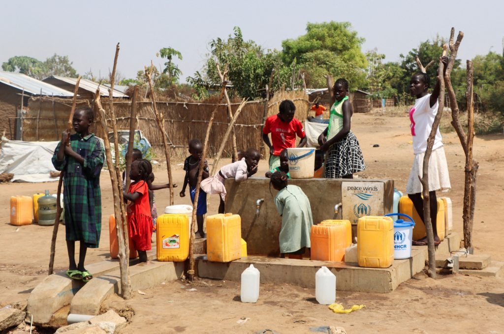 FILE PHOTO: Sudanese refugees collect water from a borehole at the Gorom Refugee camp