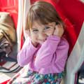 Little girl listening to audio on a Big Bus Tour