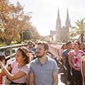 passengers on Big Bus Tours Sydney in afternoon sunlight