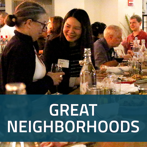 A square button with a picture of people enjoying a T or Drinks event, with the words Great Neighborhoods in white on a dark blue background