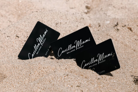 image of three gift cards in sand
