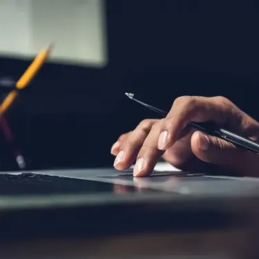 Hand of a man using laptop computer