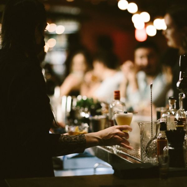 A Person Sitting At A Table With Wine Glasses