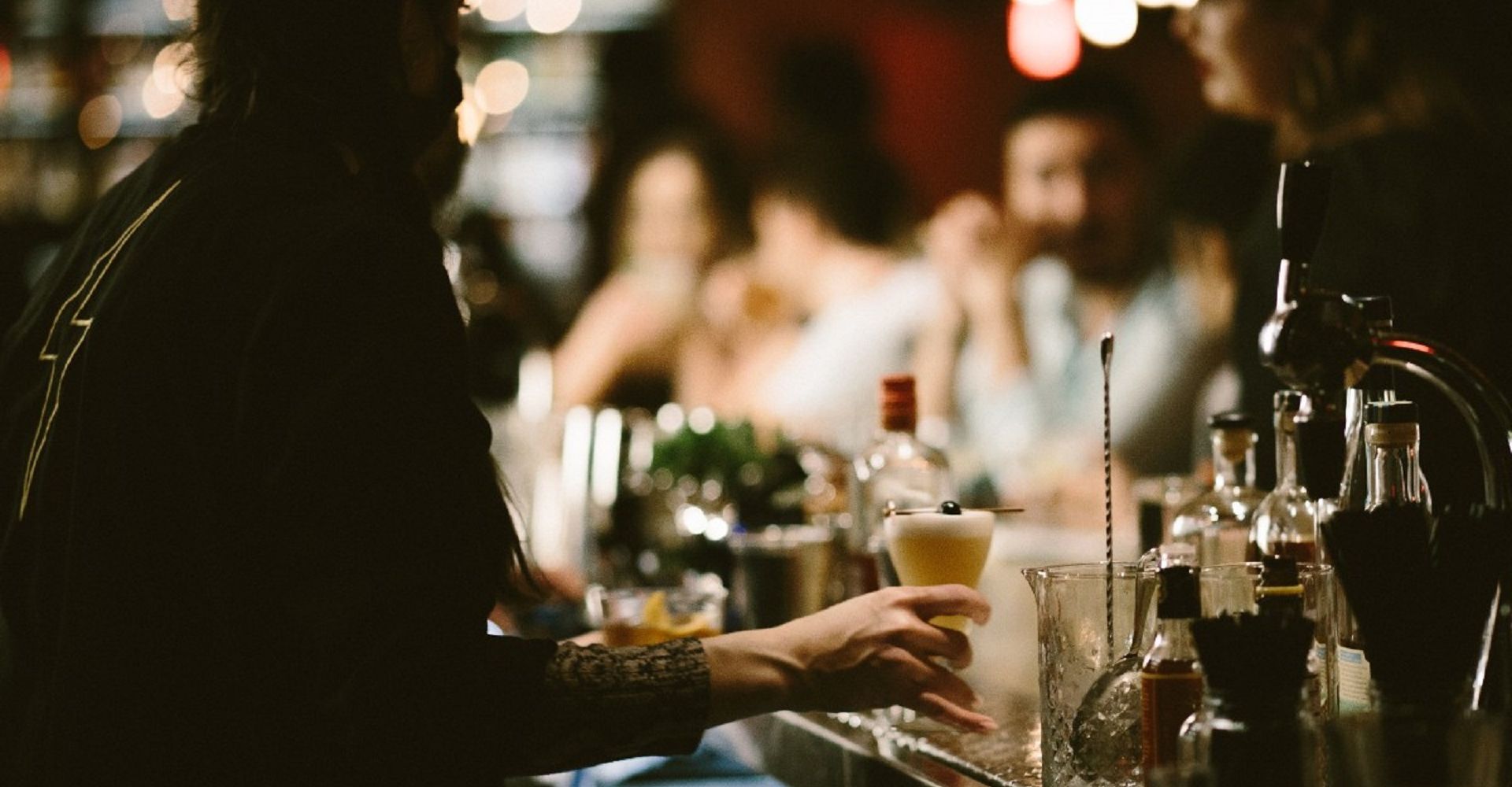 A Person Sitting At A Table With Wine Glasses