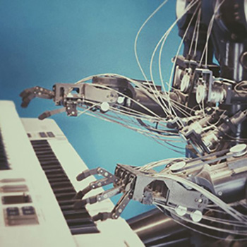 A robot plays a black and white keyboard with metallic, hinged fingers.