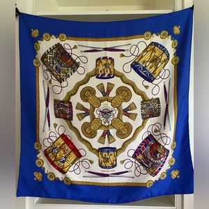 Hermes Les Tambours Silk Scarf in vibrant blues, reds & gold on field of white.