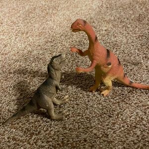 2 plastic dinosaurs