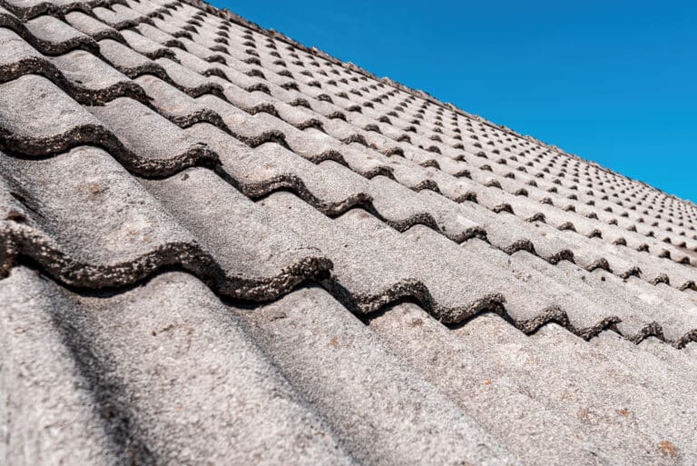 Concrete roof tiles with blue sky in background.