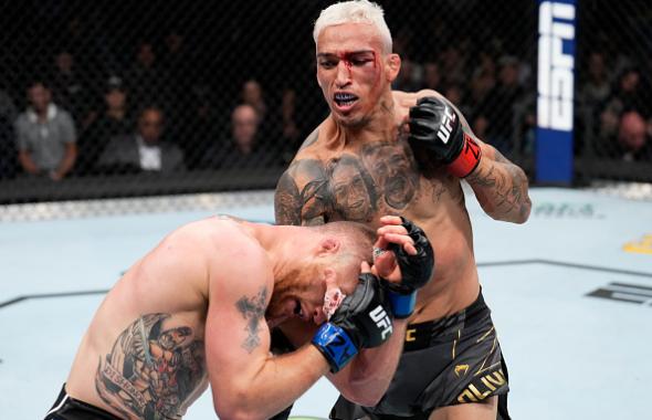 Charles Oliveira of Brazil punches Justin Gaethje in the UFC lightweight championship fight during the UFC 274 event at Footprint Center on May 07, 2022 in Phoenix, Arizona. (Photo by Chris Unger/Zuffa LLC)