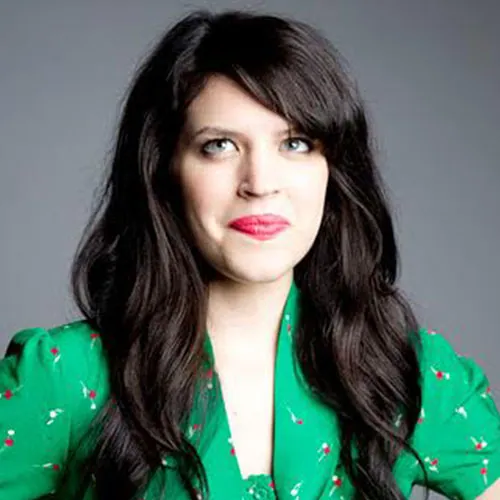 Emily Axford in a green shirt in front of a grey background