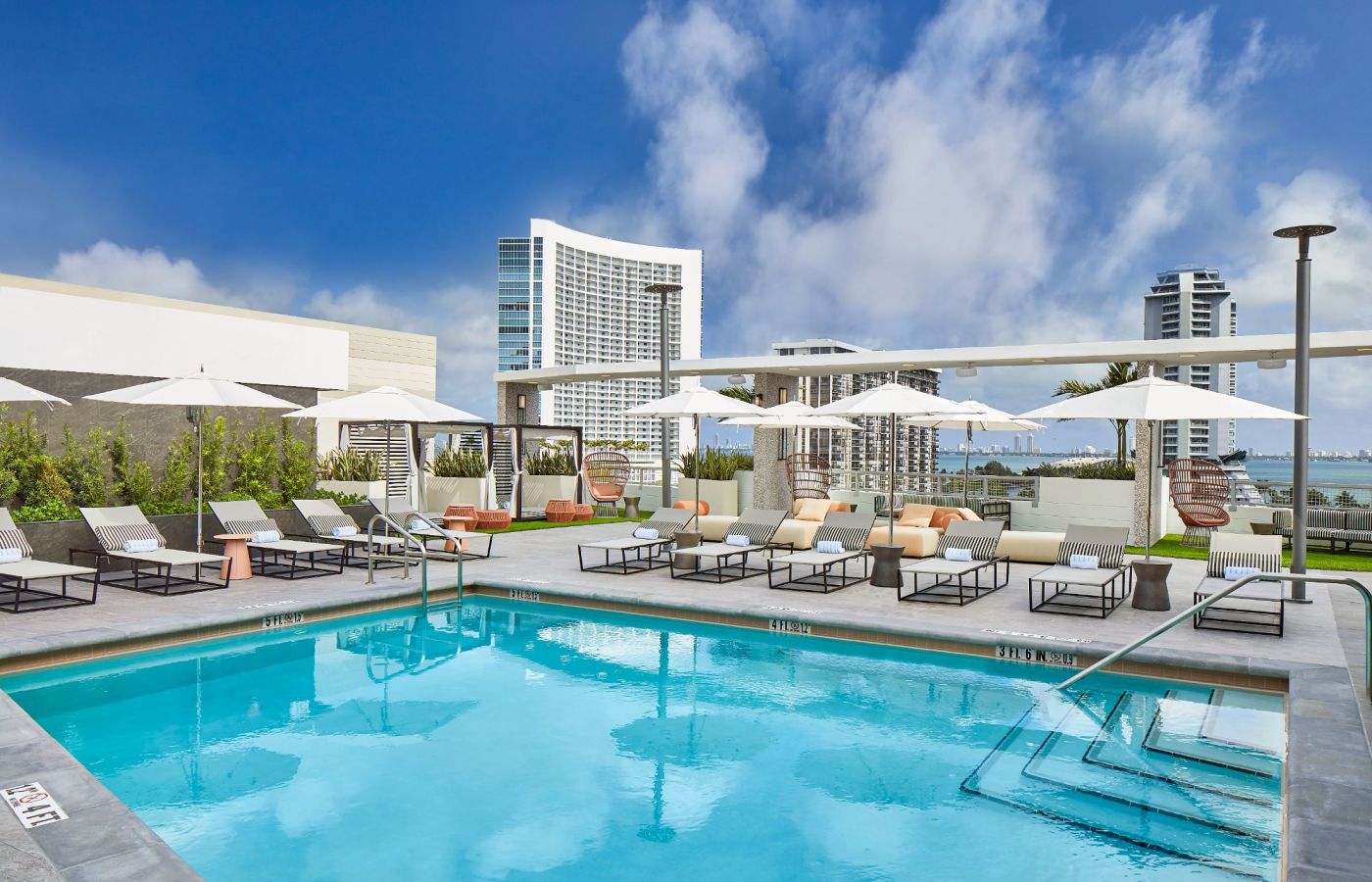 A Pool With Chairs Around It