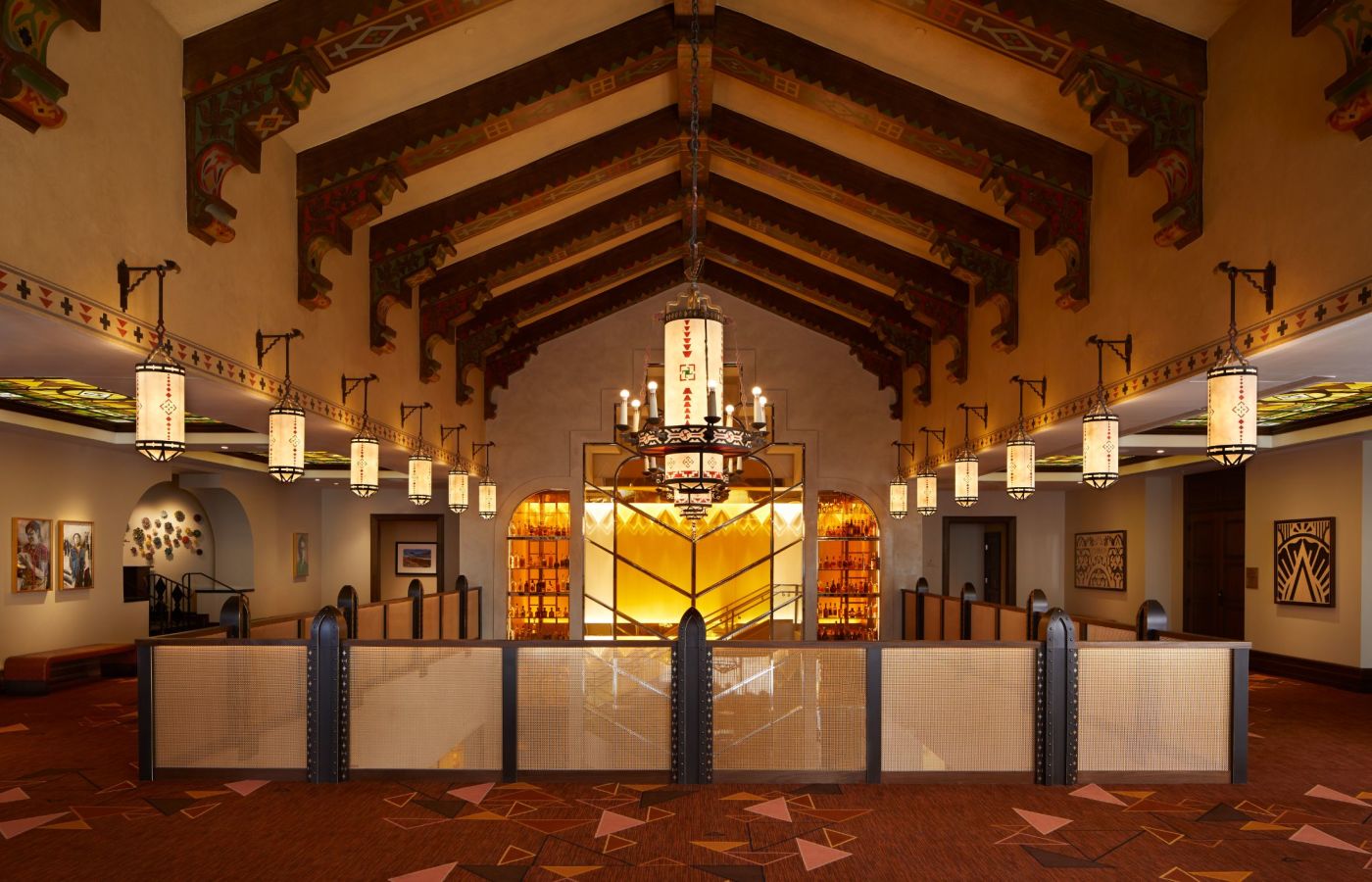 A Large Room With A Stage And Chandeliers