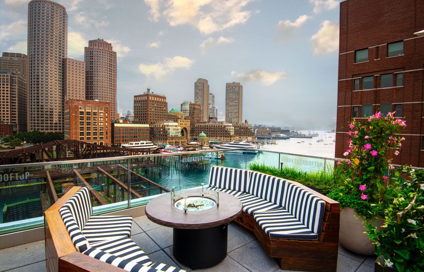 A Table And Chairs On A Deck Overlooking A City